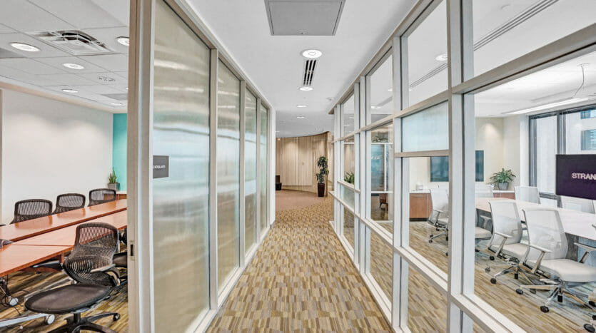 Hallway between two sleek, modern conference rooms